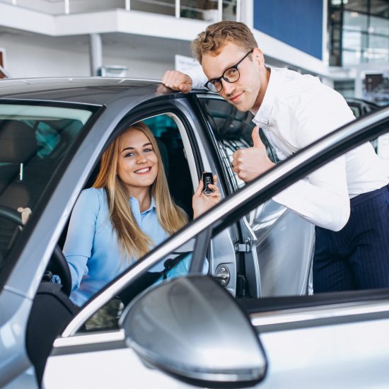 Young woman testing a car from a car showroom Young woman testing a car from a car showroom